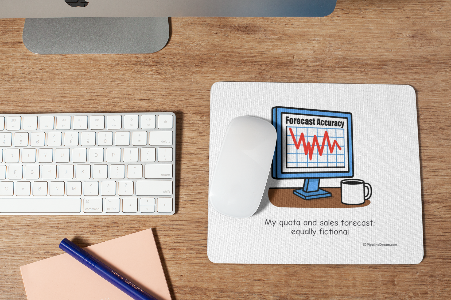 funny sales mouse pad with “Forecast & Quota: Both Fictional” cartoon - shown on wooden desk with keyboard - Pipeline Dream