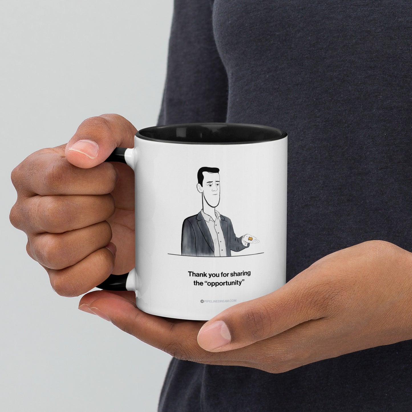 Sales humor mug held in hand featuring the Golden Lead cartoon
