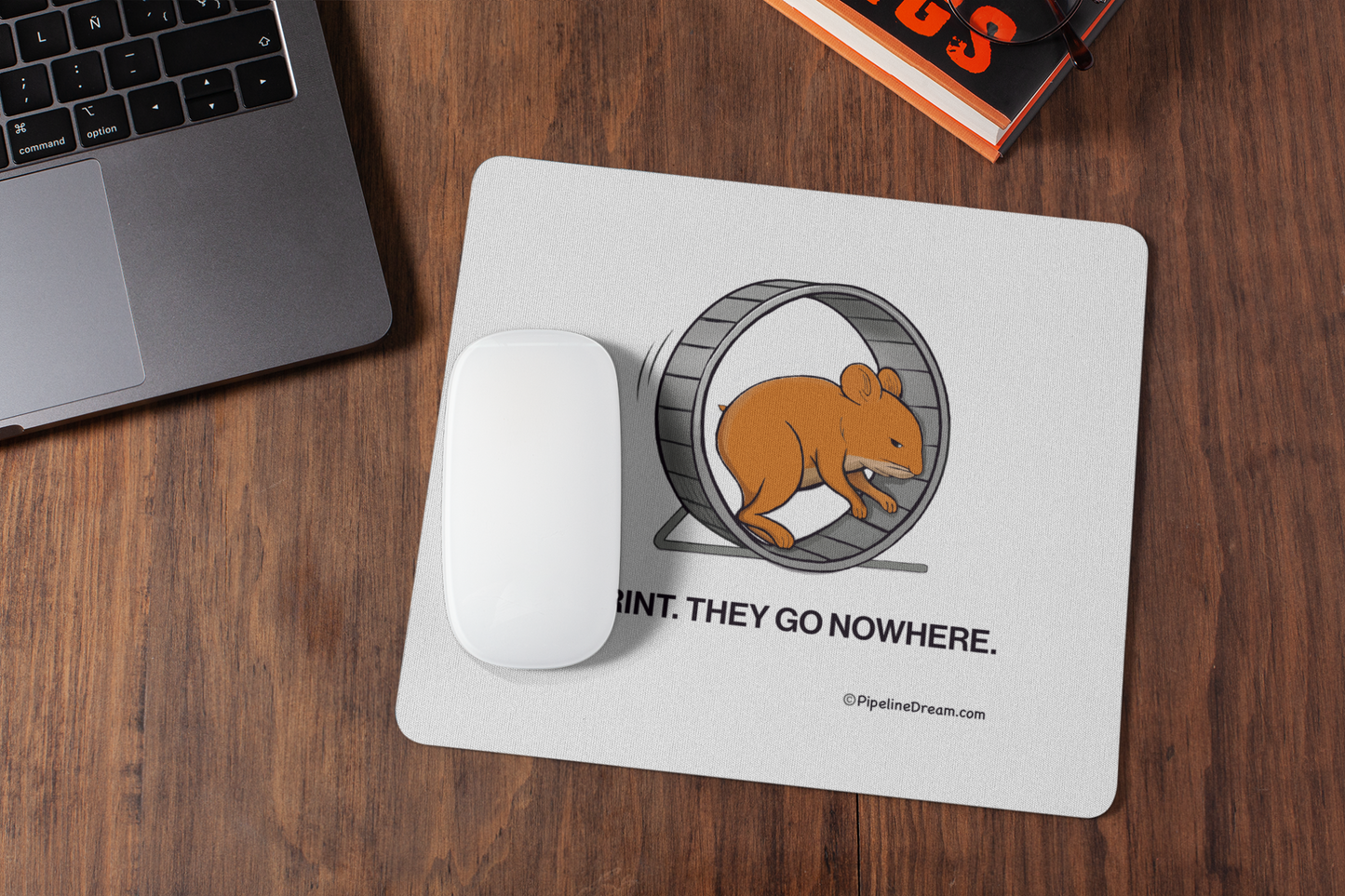 sales desk with "I Sprint They Go Nowhere" sales humor mouse pad and laptop