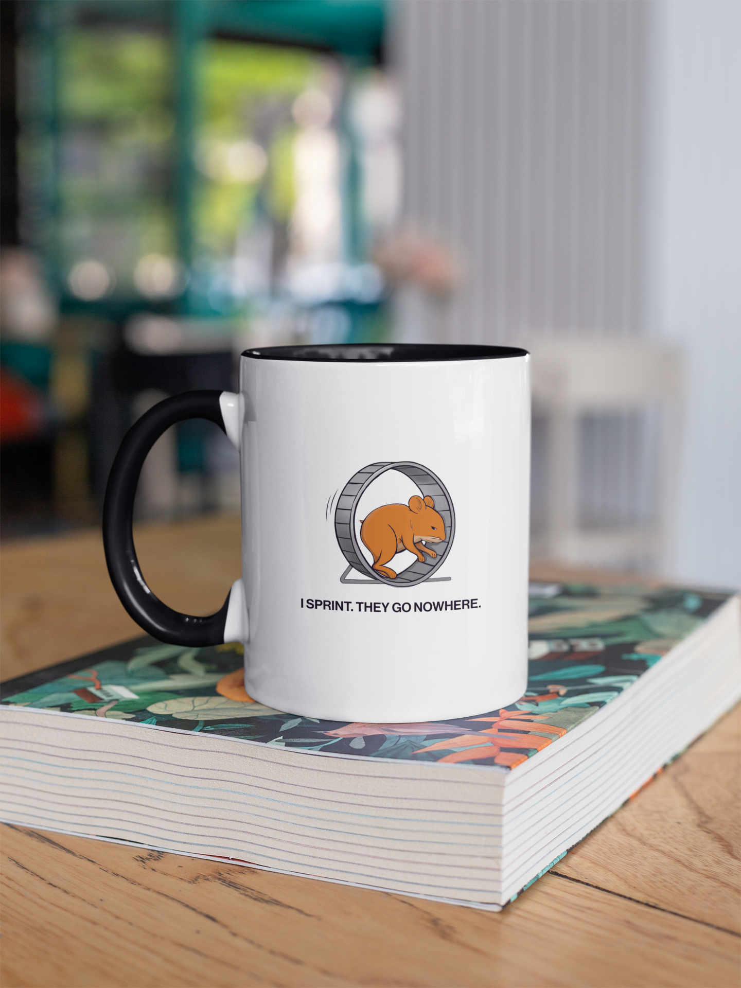 sales humor mug on book featuring hamster wheel cartoon and caption “I Sprint. They Go Nowhere.”