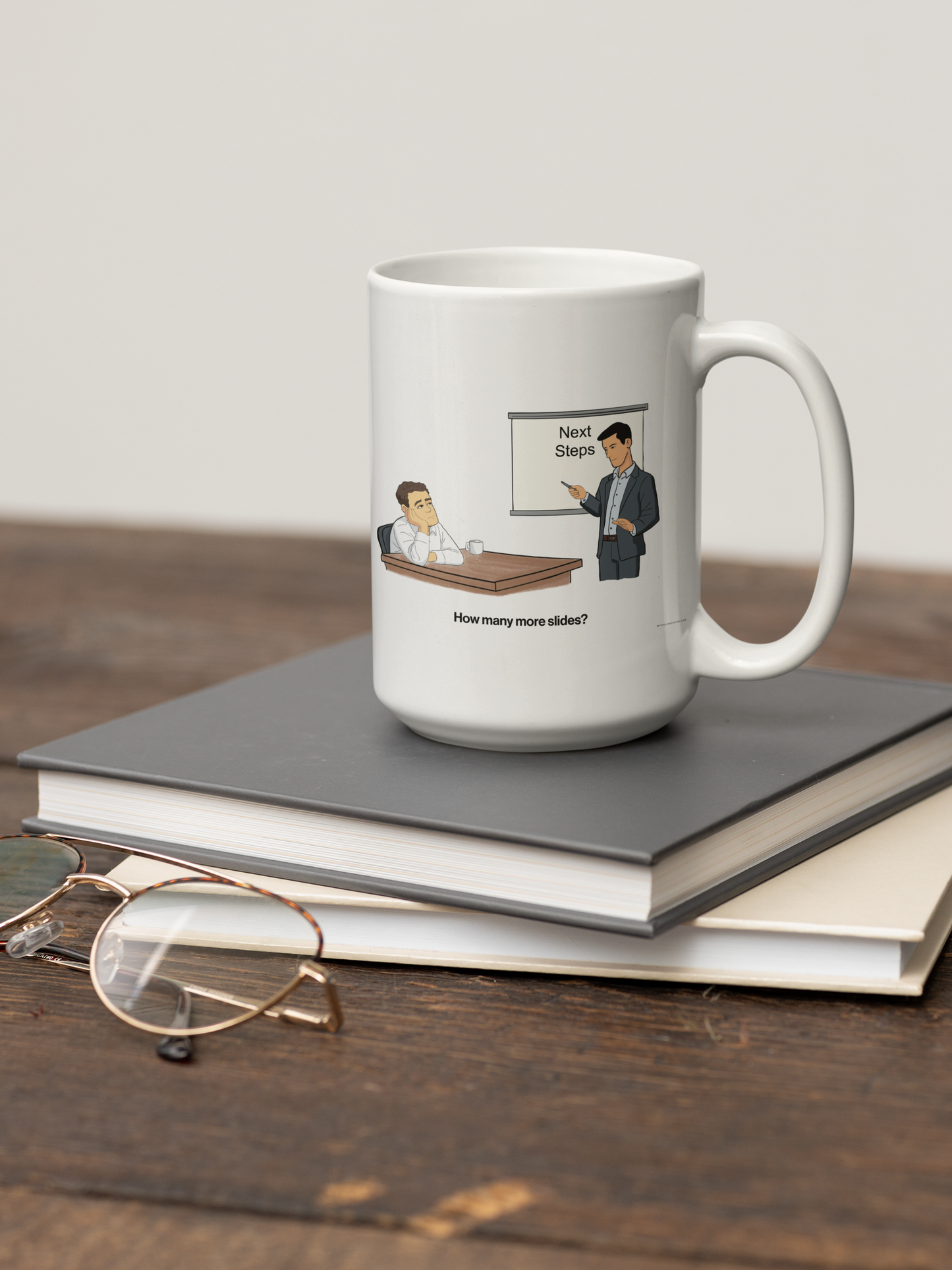 sales humor mug featuring “Next Steps” cartoon sitting on books on desk